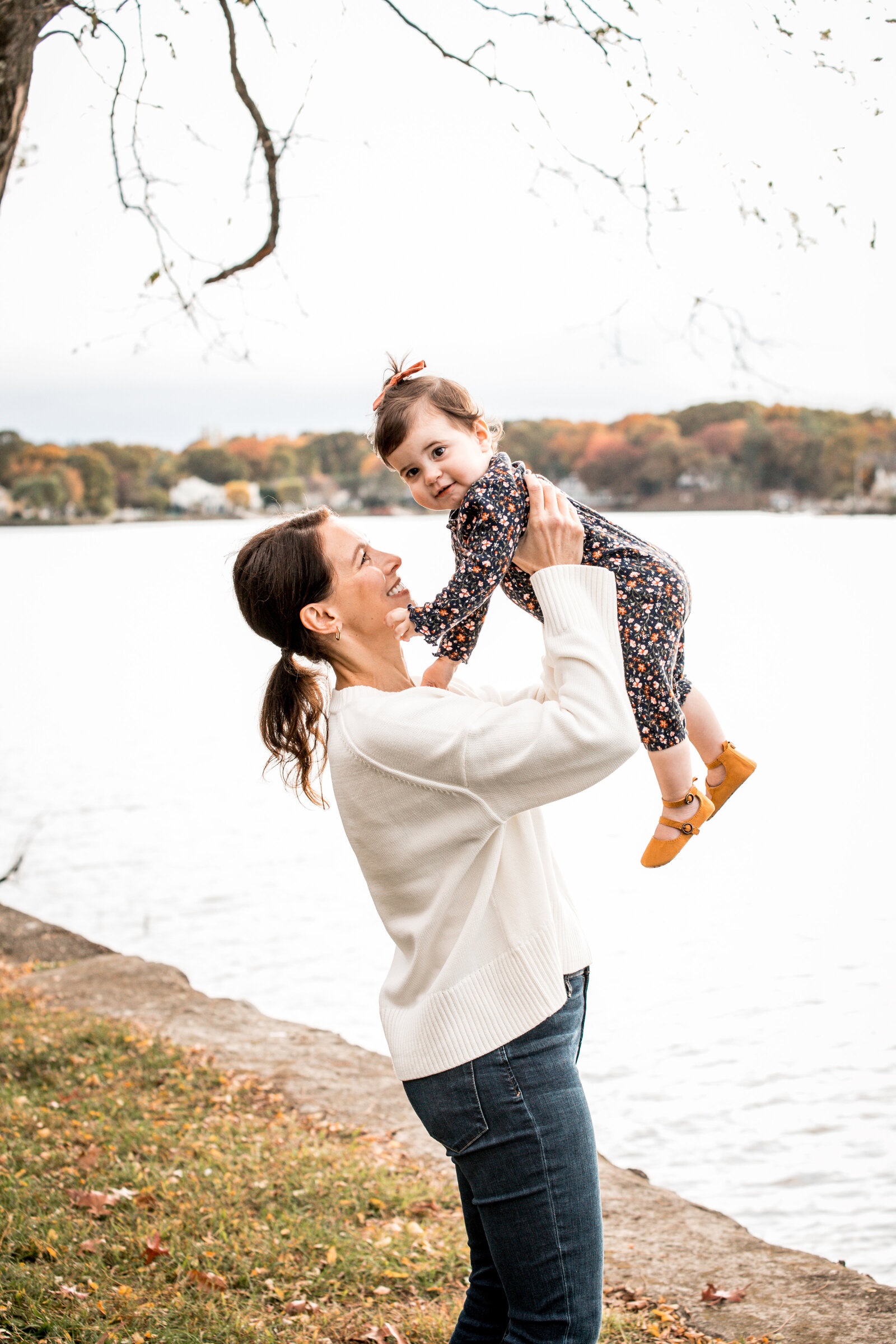 mom laughing with her daughter at her westport ct family session