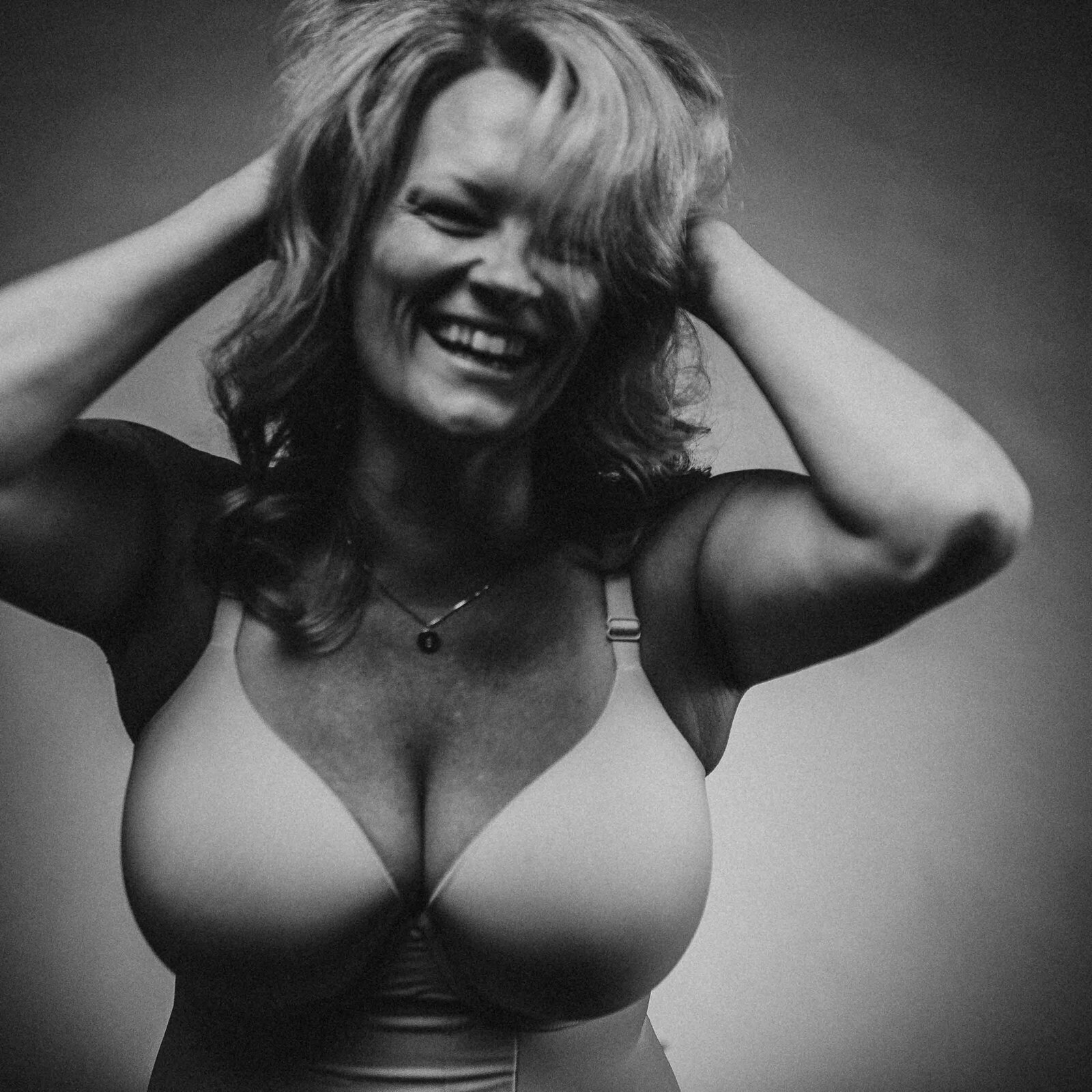 black and white photo of a laughing woman