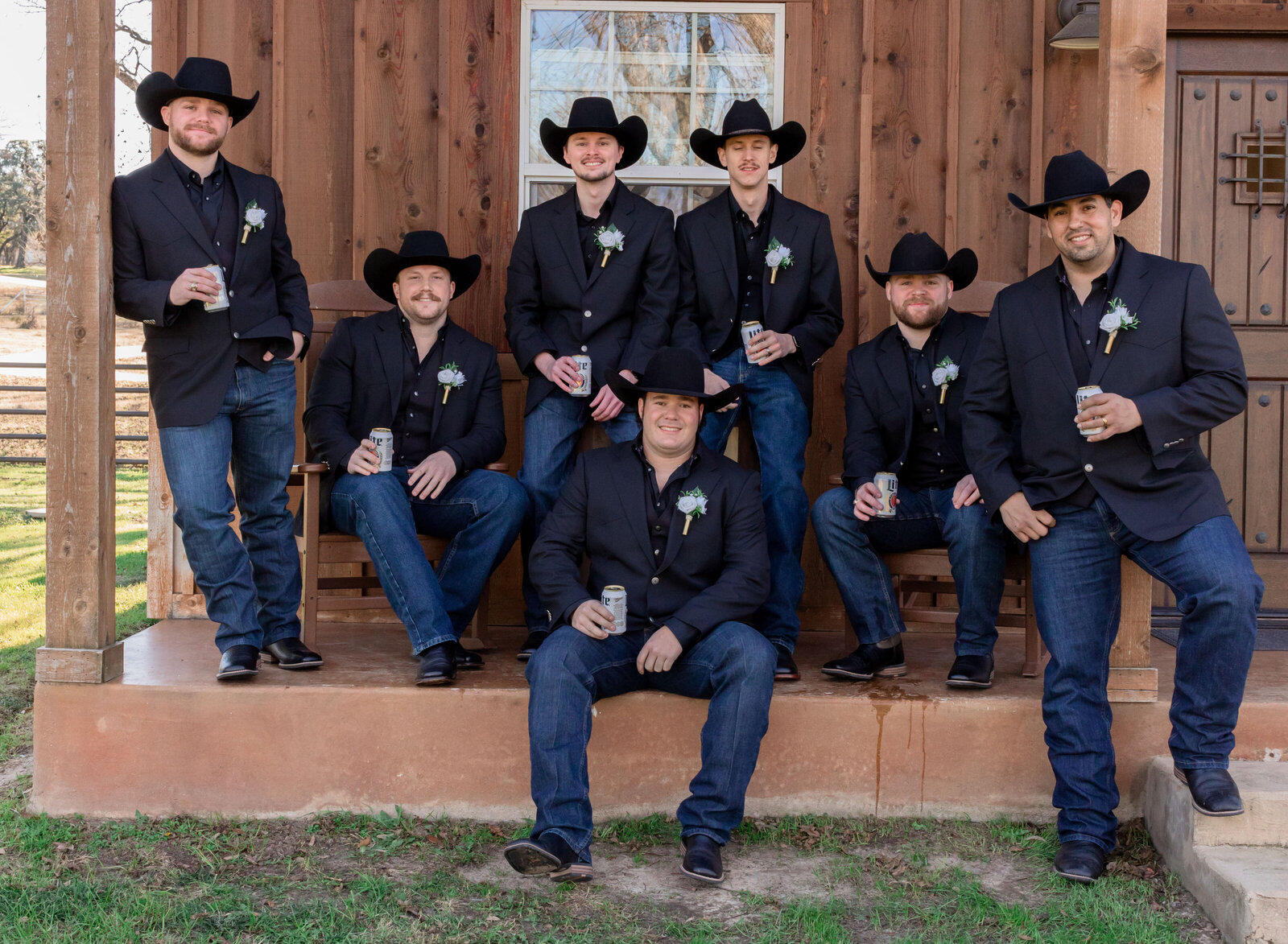 groom and groomsmen on porch cowboy hats and boots