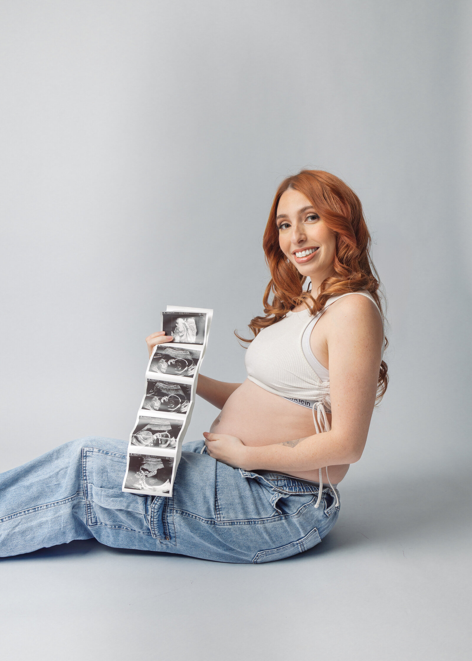 Expecting mom proudly displaying baby’s ultrasound image – Bergen County maternity photography