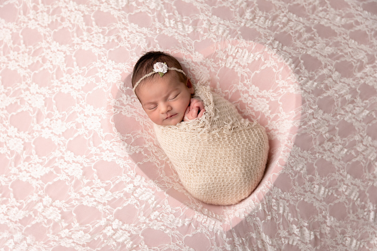 baby sleeping in pink lace heart