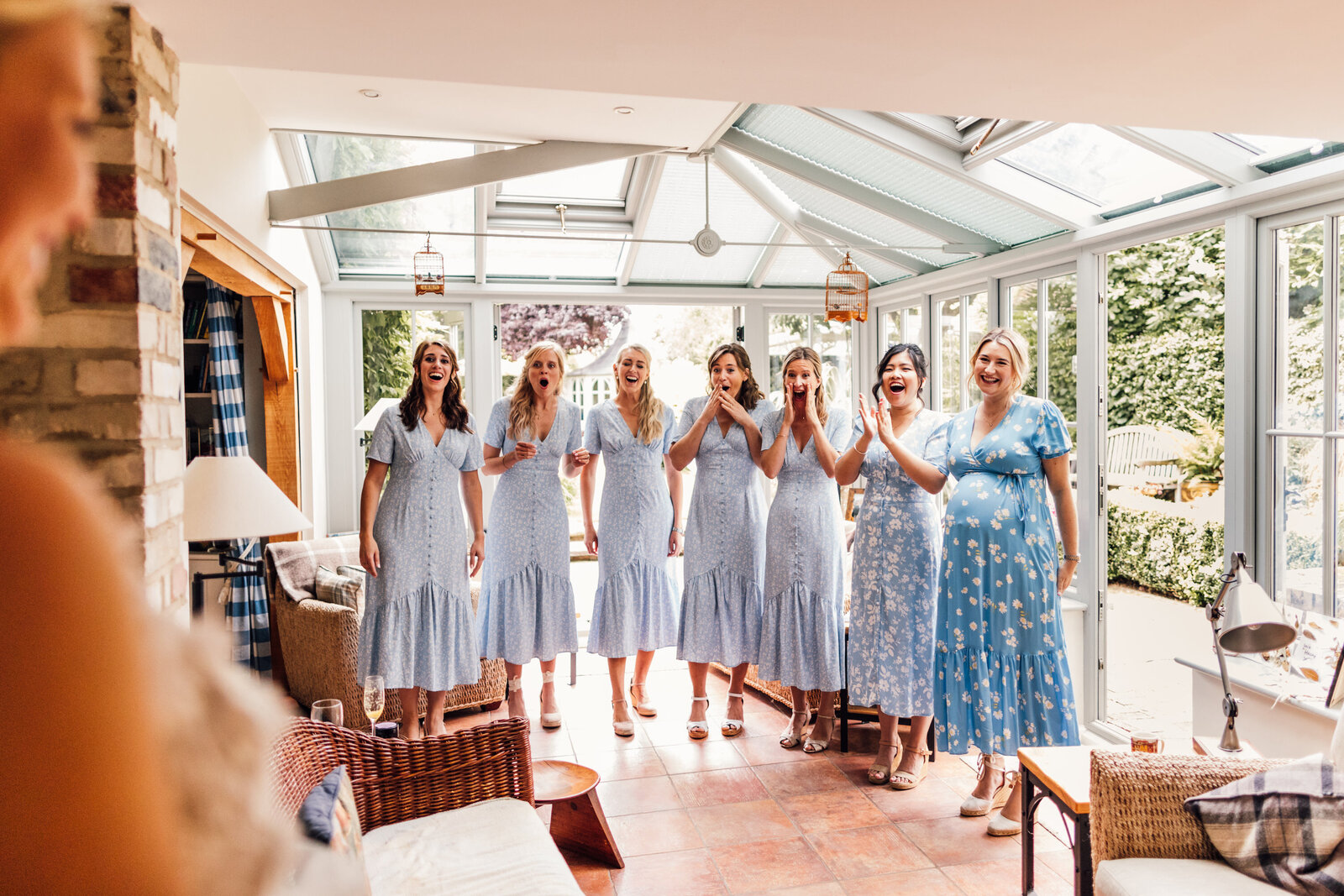 Bridal Party in Blue dresses seeing Bride for the first time