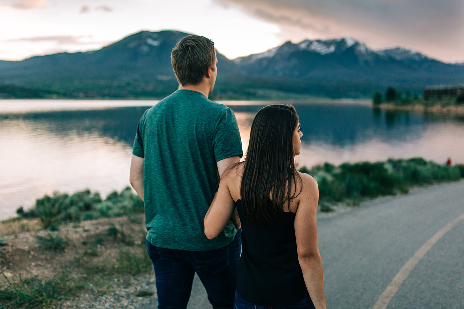 Couple snuggled up looking at the summer sunset in Silverthorne, CO