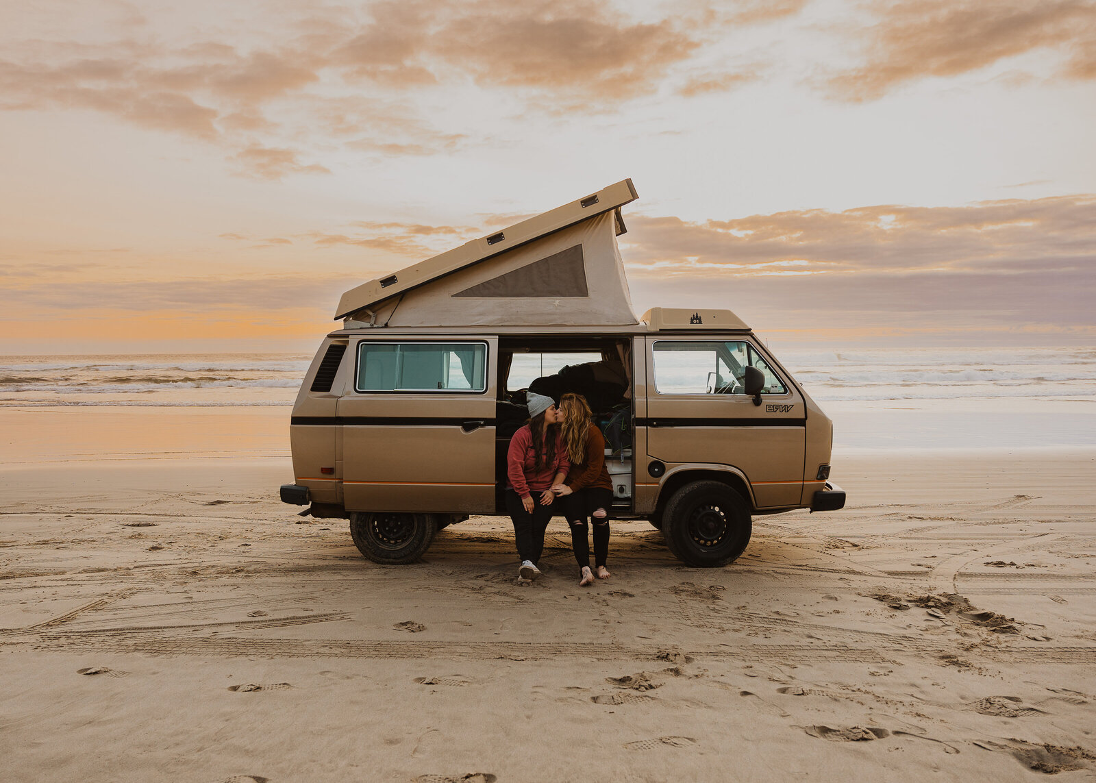 An lgbtq couple gets their engagement photos taken in a westfalia van on the coast of Oregon