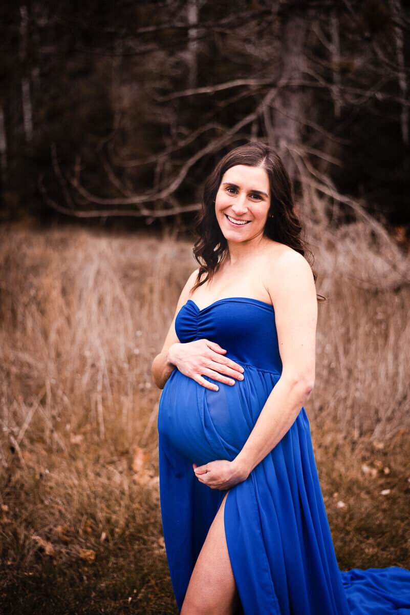 Expecting mom models blue gown for Toronto maternity photographer