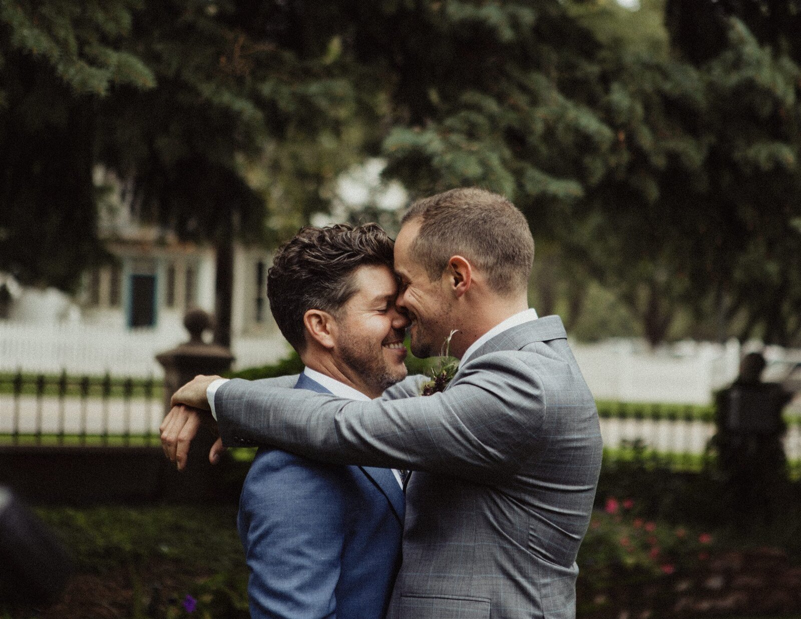 Two men embracing at LGBTQ wedding venue near Denver