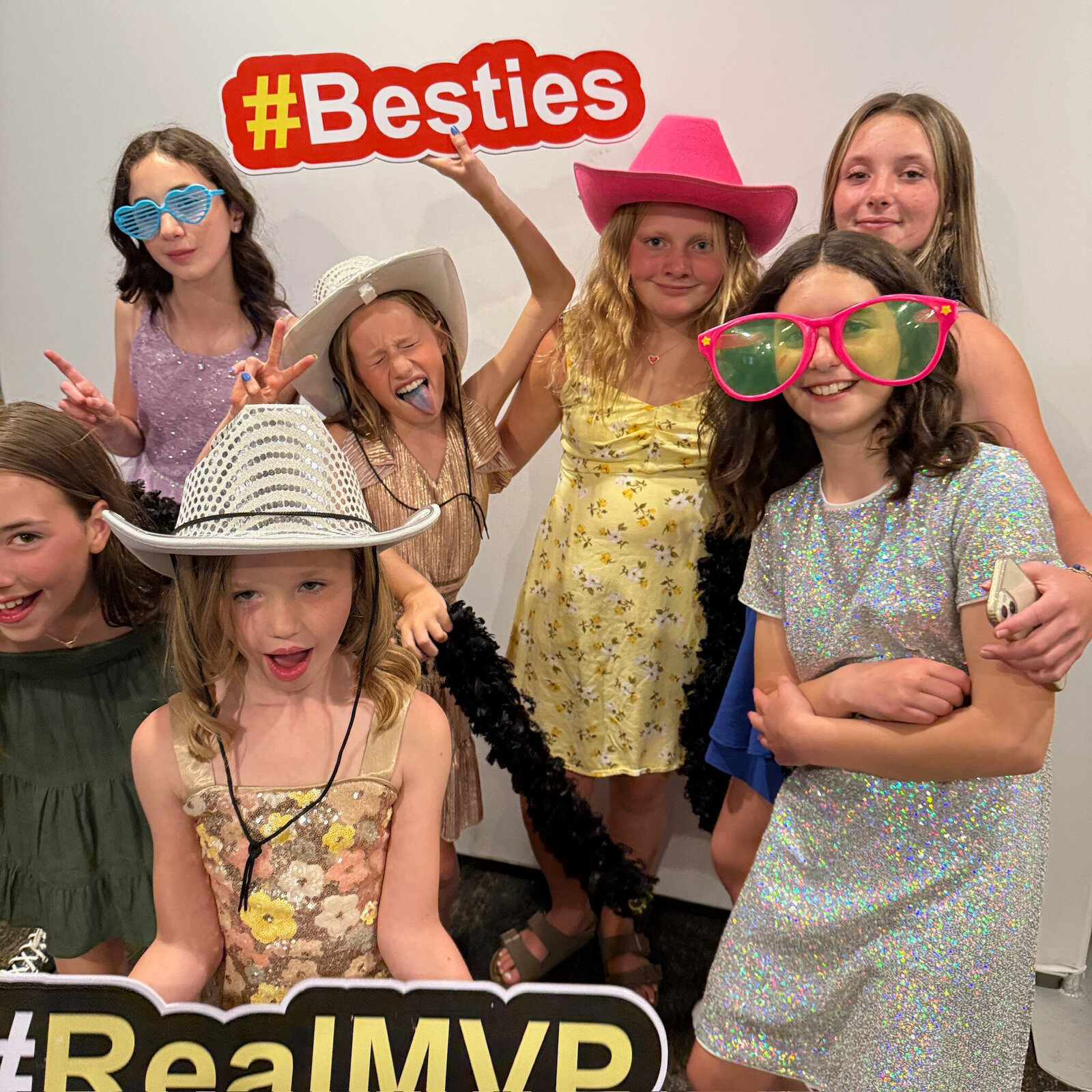 group of kids in a photo booth doing a funny pose
