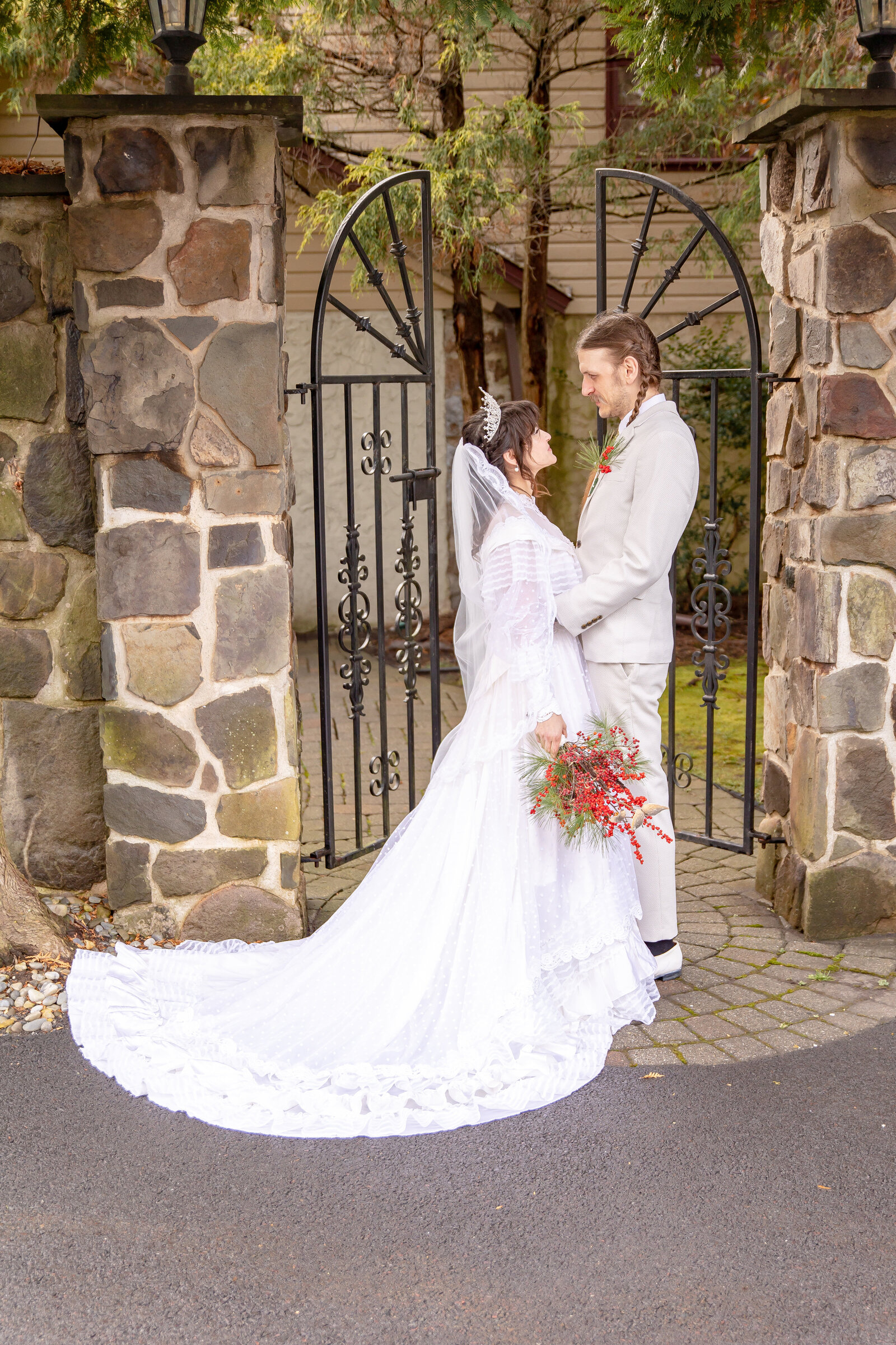 bride and groom together in front of gate