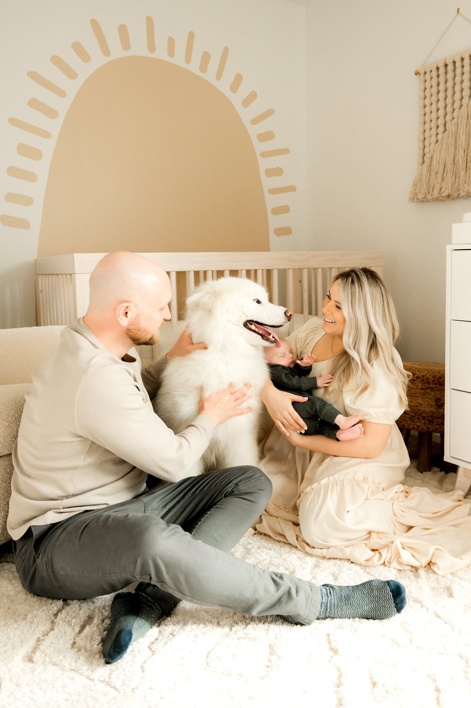 family with their dog in the nursery for an in home newborn photography session
