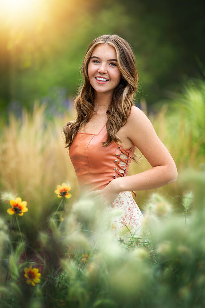 relaxed-genuine-candid-senior-girl-smiling-freckles-outdoor-sunlight-field-grass-denver-botanical-gardens