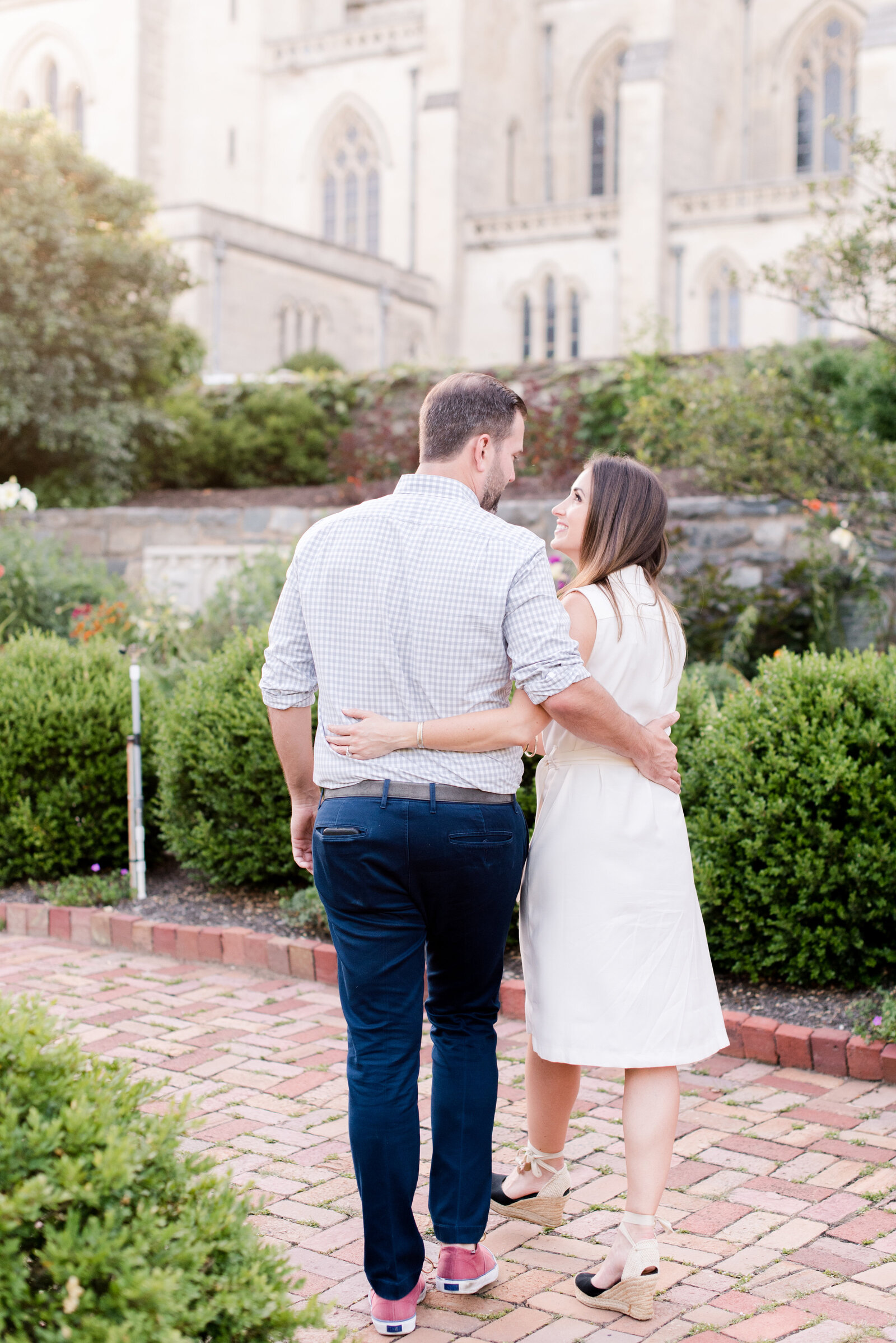 engaged couple taking engagement photos at National Cathedral engagement session
