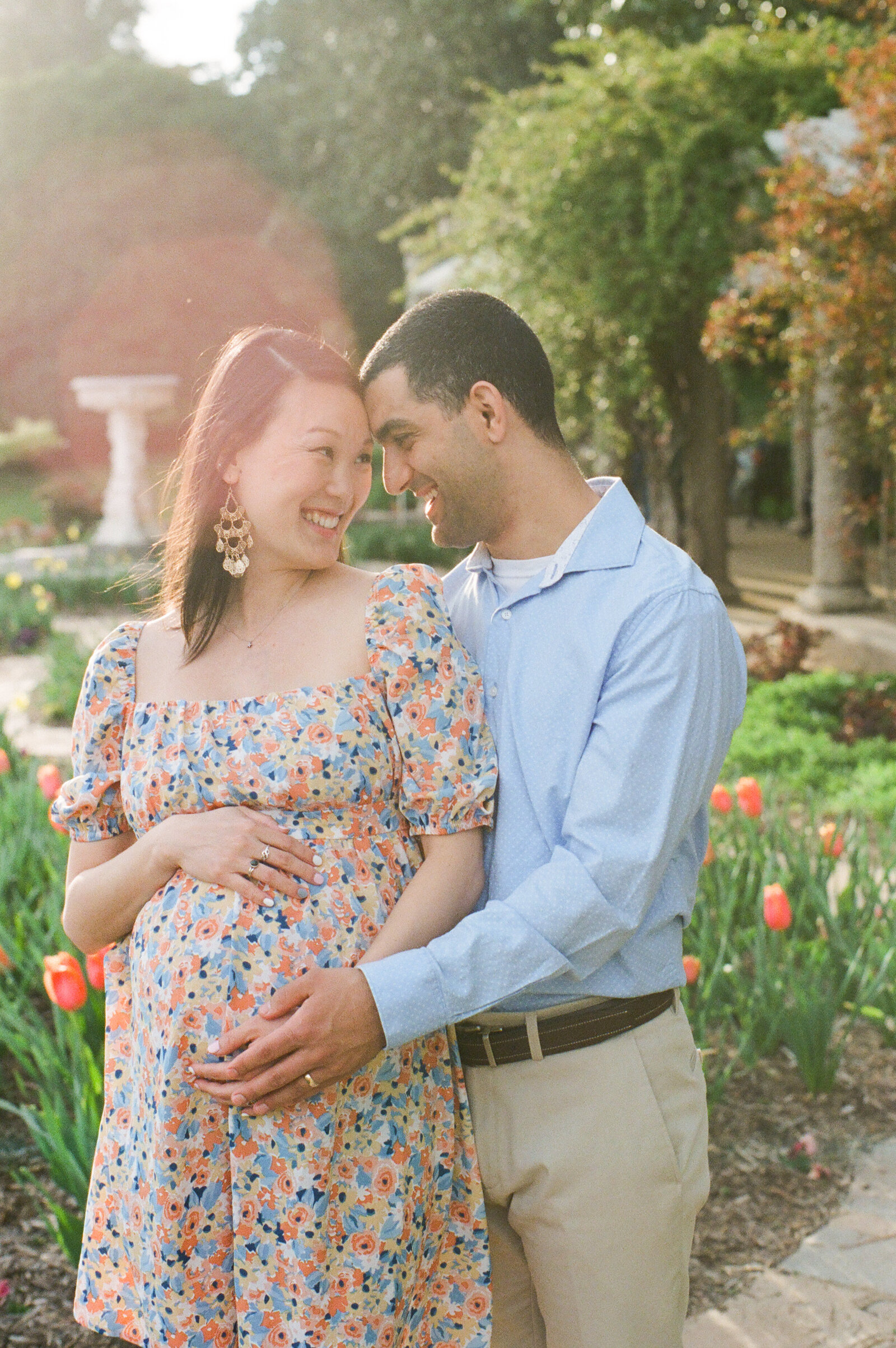 film photo of maternity couple in garden