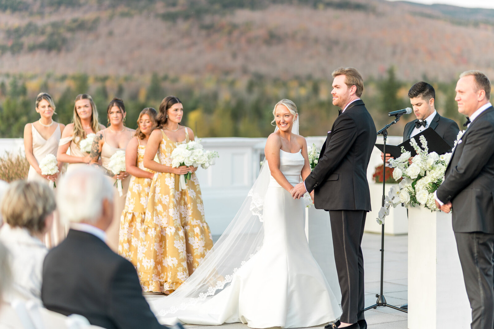 Bright and airy outdoor wedding ceremony at Omni Mt. Washington Hotel with bride, groom, and bridal party — luxury wedding photography by Sarah Surette Photography.
