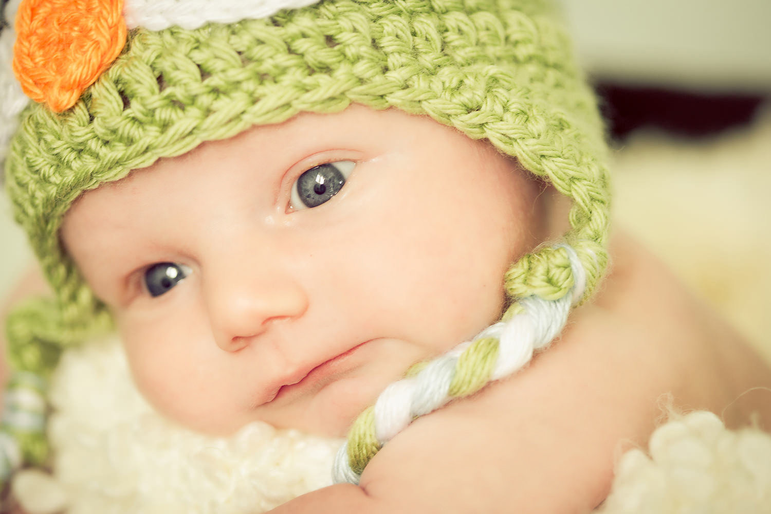san diego newborn photographer  | newborn with cute beanie that has a cute green beanie big blue eyes