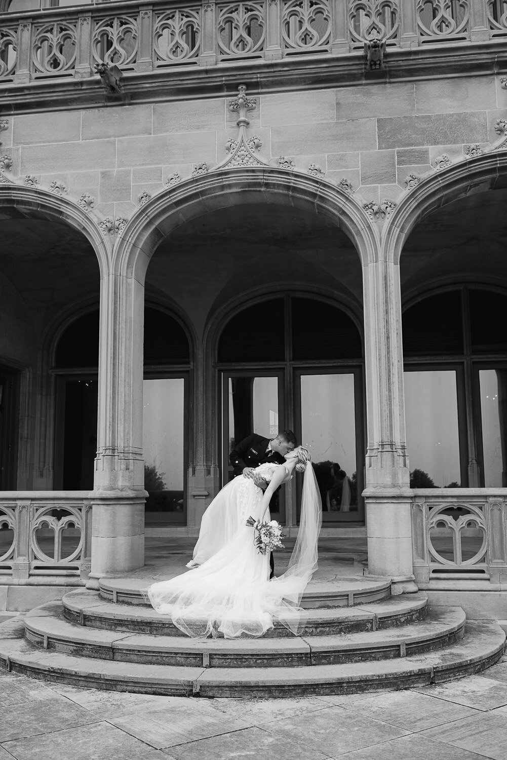 couple dip in front of columns at Newport mansion