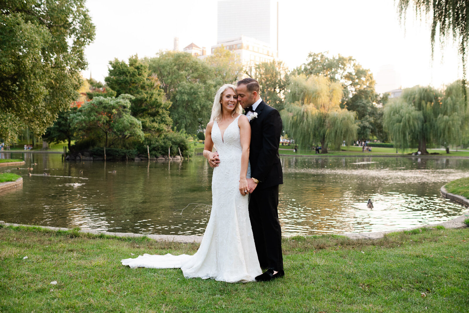 bride and groom portrait in Boston Commons in front of water