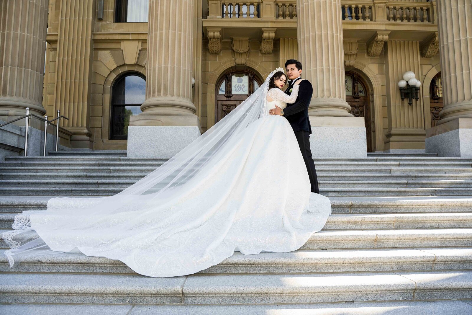 Afghani wedding Couple  at the Edmonton Legislative Grounds in Edmonton, Bride is wearing an amzing wedding gown with long train