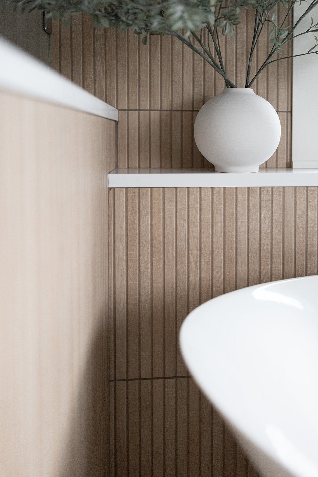 michele rosenboom design clean country renovation slatted wood accent wall and plant in white round vase