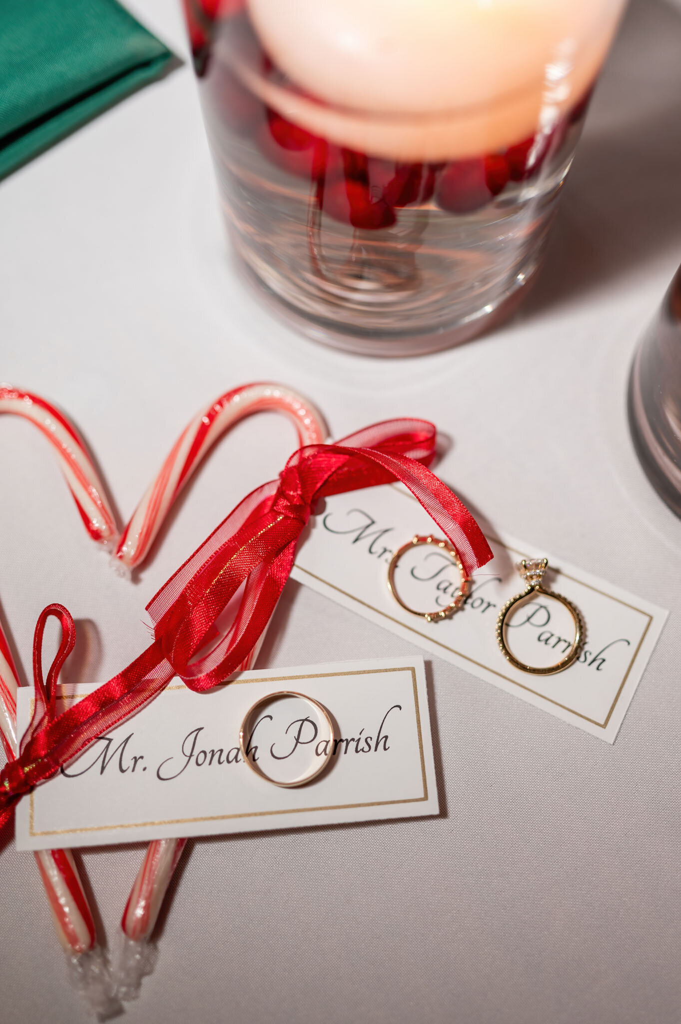 Wedding rings and candy canes with name cards and ribbon