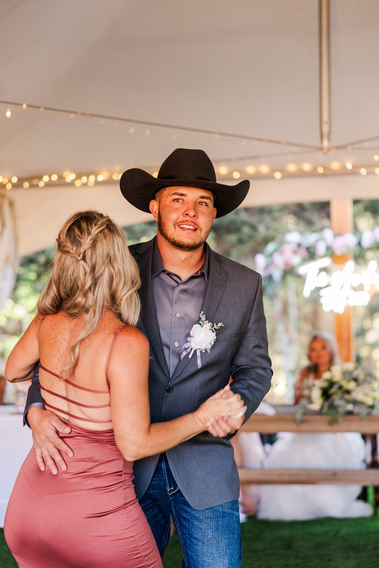 Groom and mom dance at wedding with lots of emotion and smiles