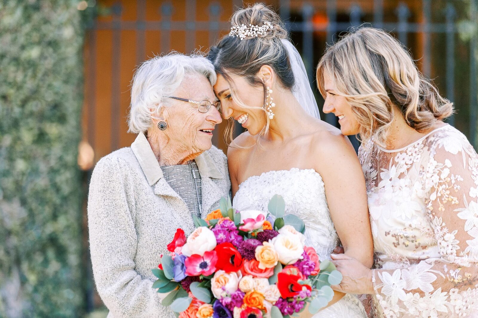 Bride shares a sweet moment with her mom and grandma.