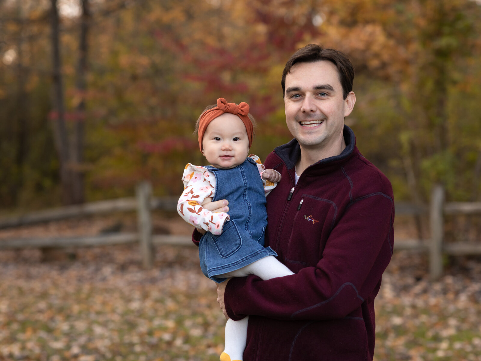 dad holding baby girl for family photos