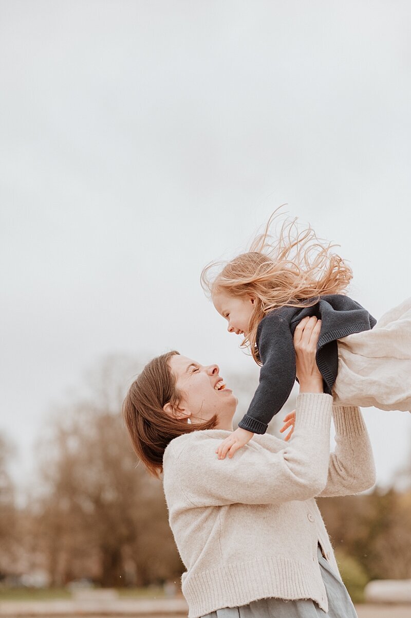 Mom throwing toddler daughter in the air with Vancouver Family Photographer