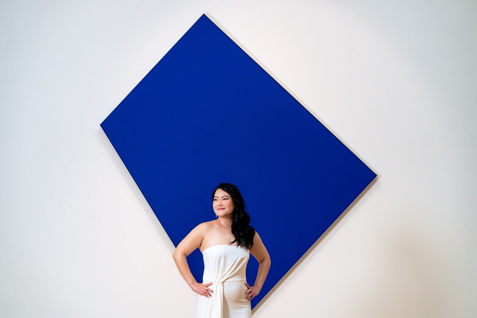 asian bride poses in front of modern art at her North Carolina Museum of Art wedding