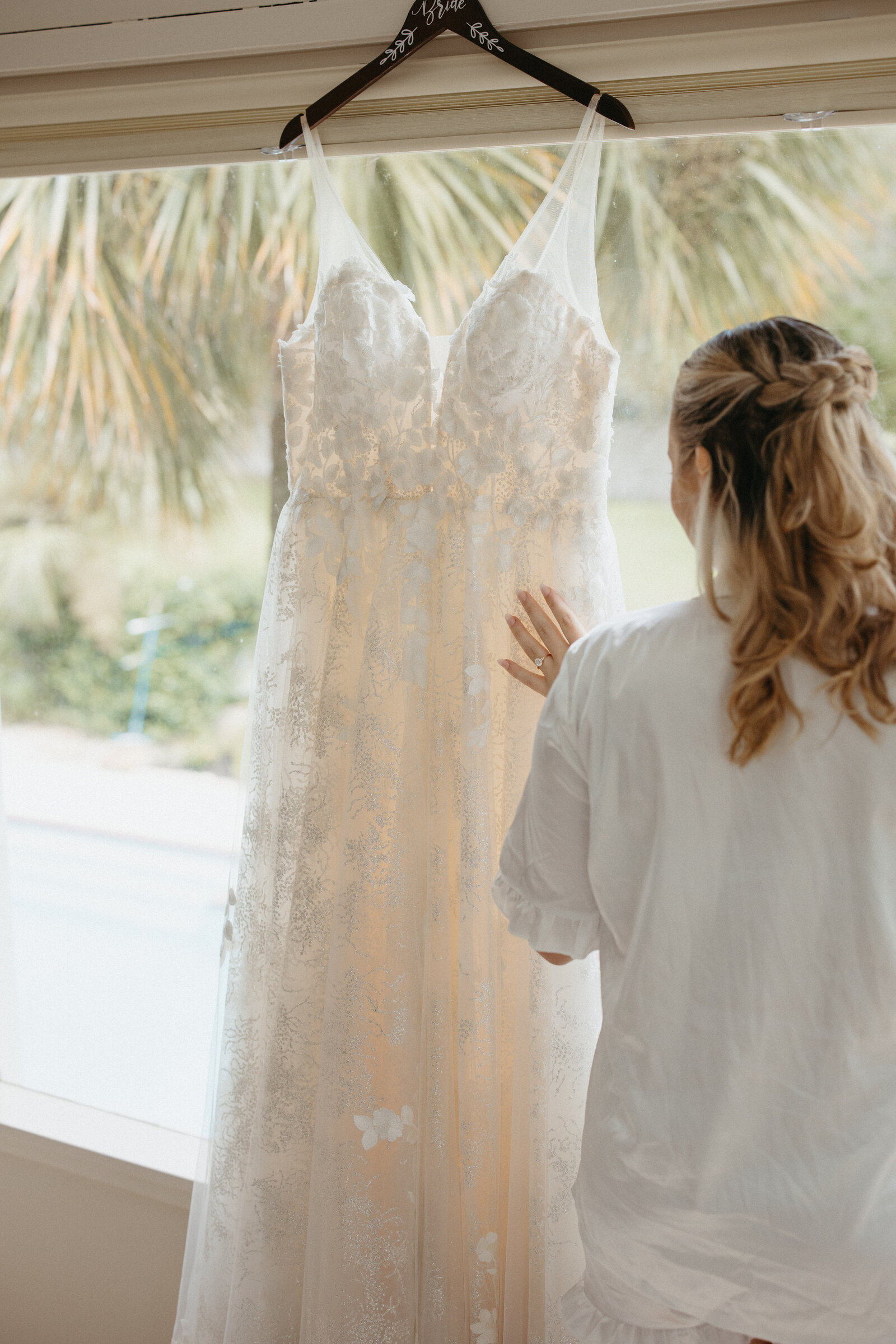 Bride touching her wedding dress