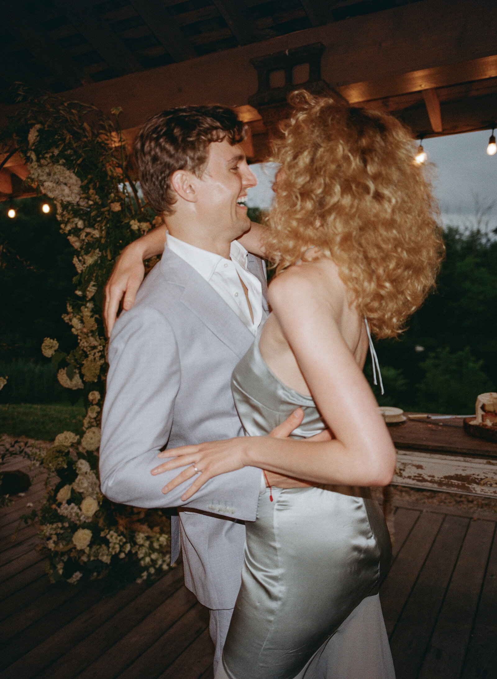 Direct flash film photo of wedding guest couple dancing under a pavilion at dusk in Hudson Valley  