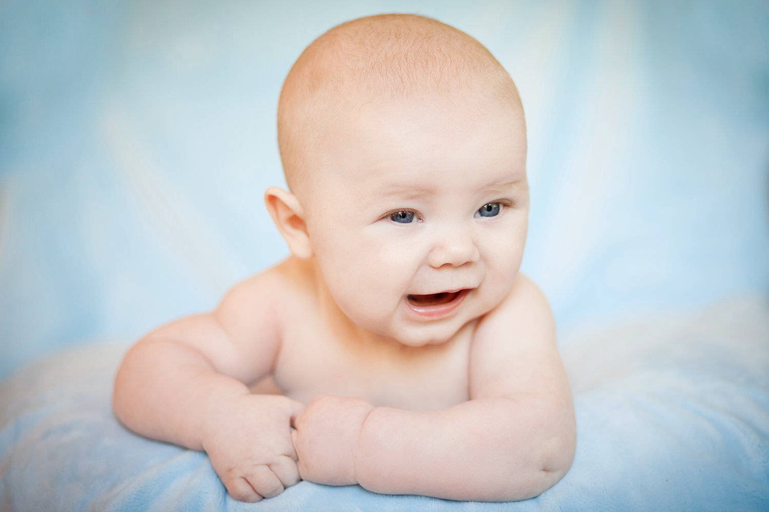san diego newborn photography | baby bot with blue background and huge smile