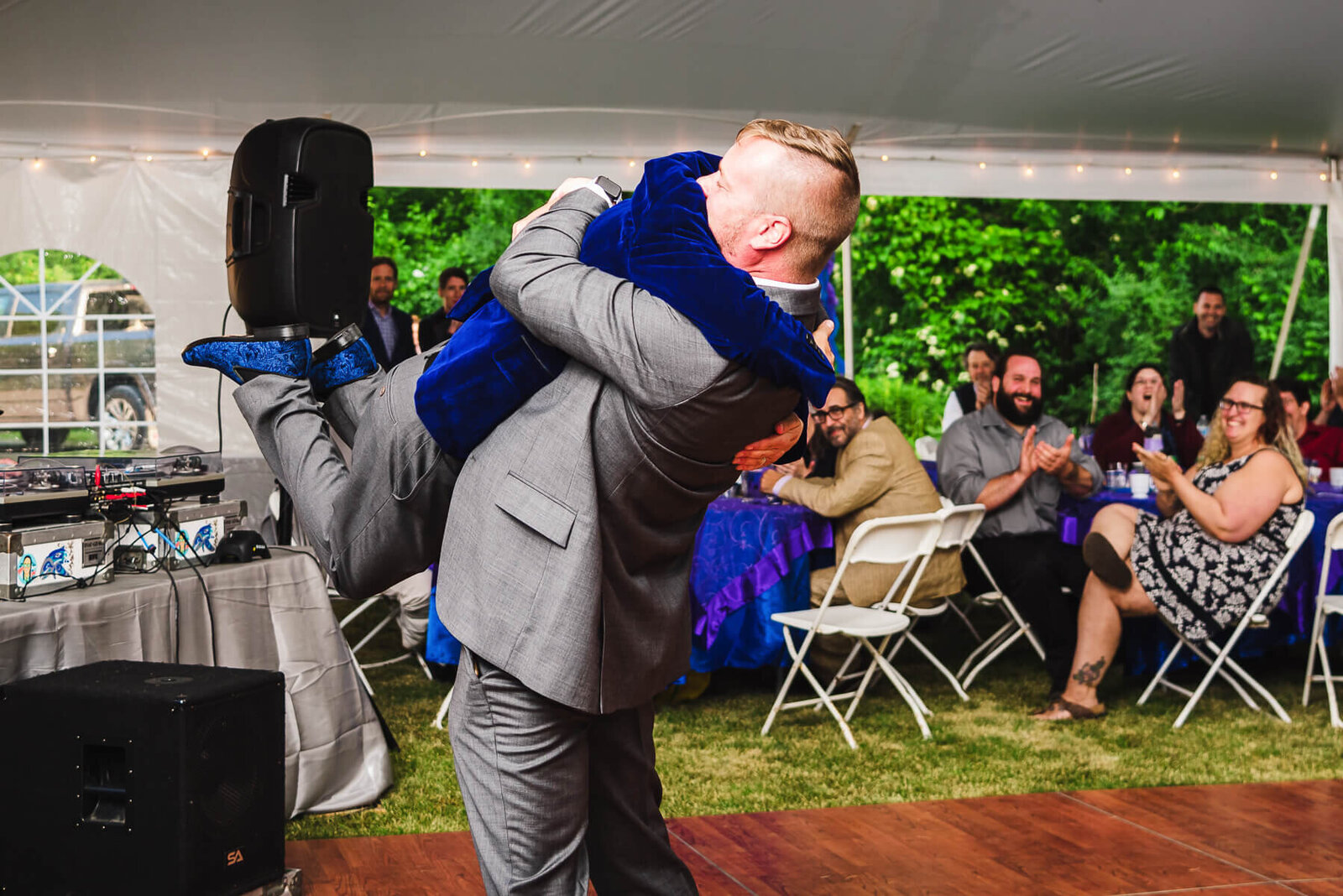 groomsmen lifting groom at wedding reception