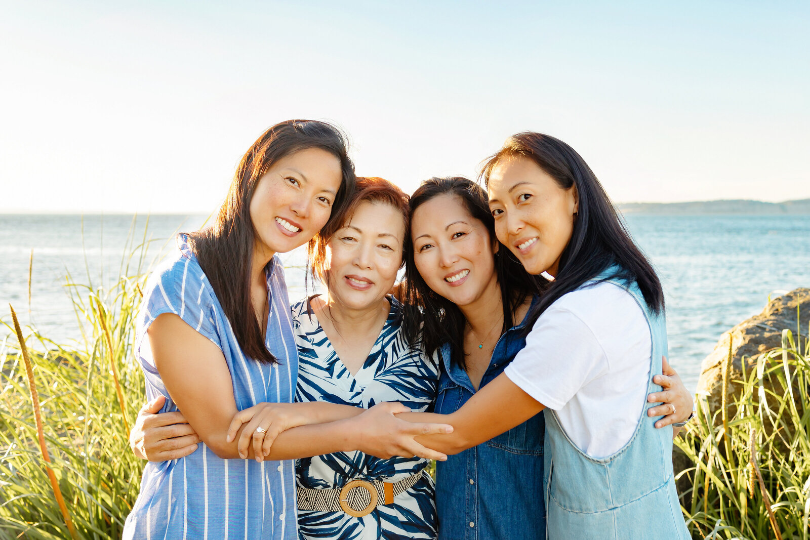 Mother and adult daughters hug at Point No Point