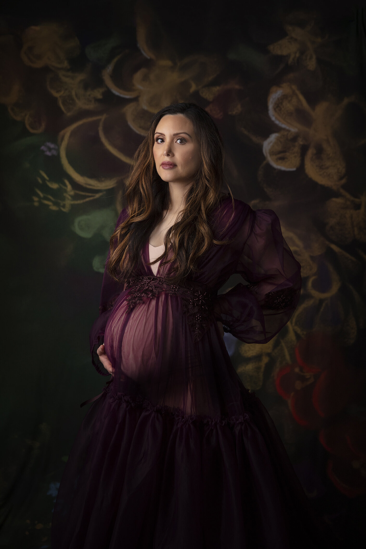 Pregnant woman poses in Katharina Hakaj maternity dress.