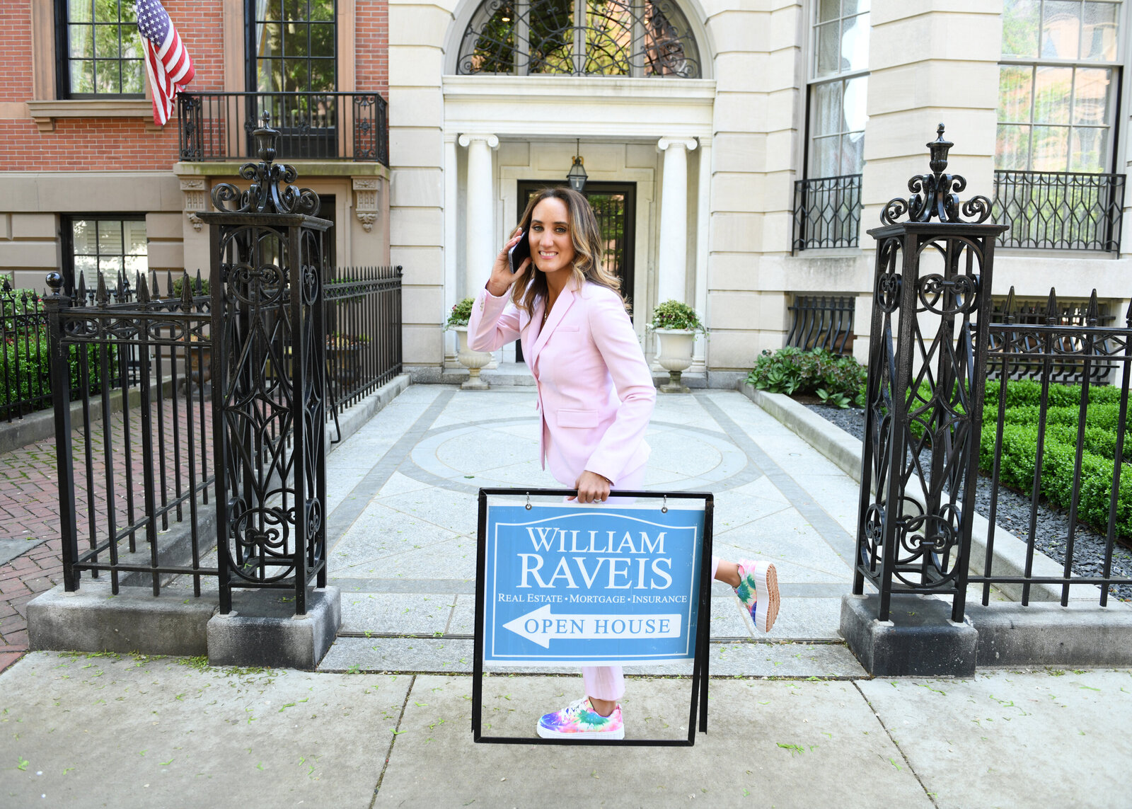 Real Estate Brand Photoshoot in Boston of agent holding a branded sign