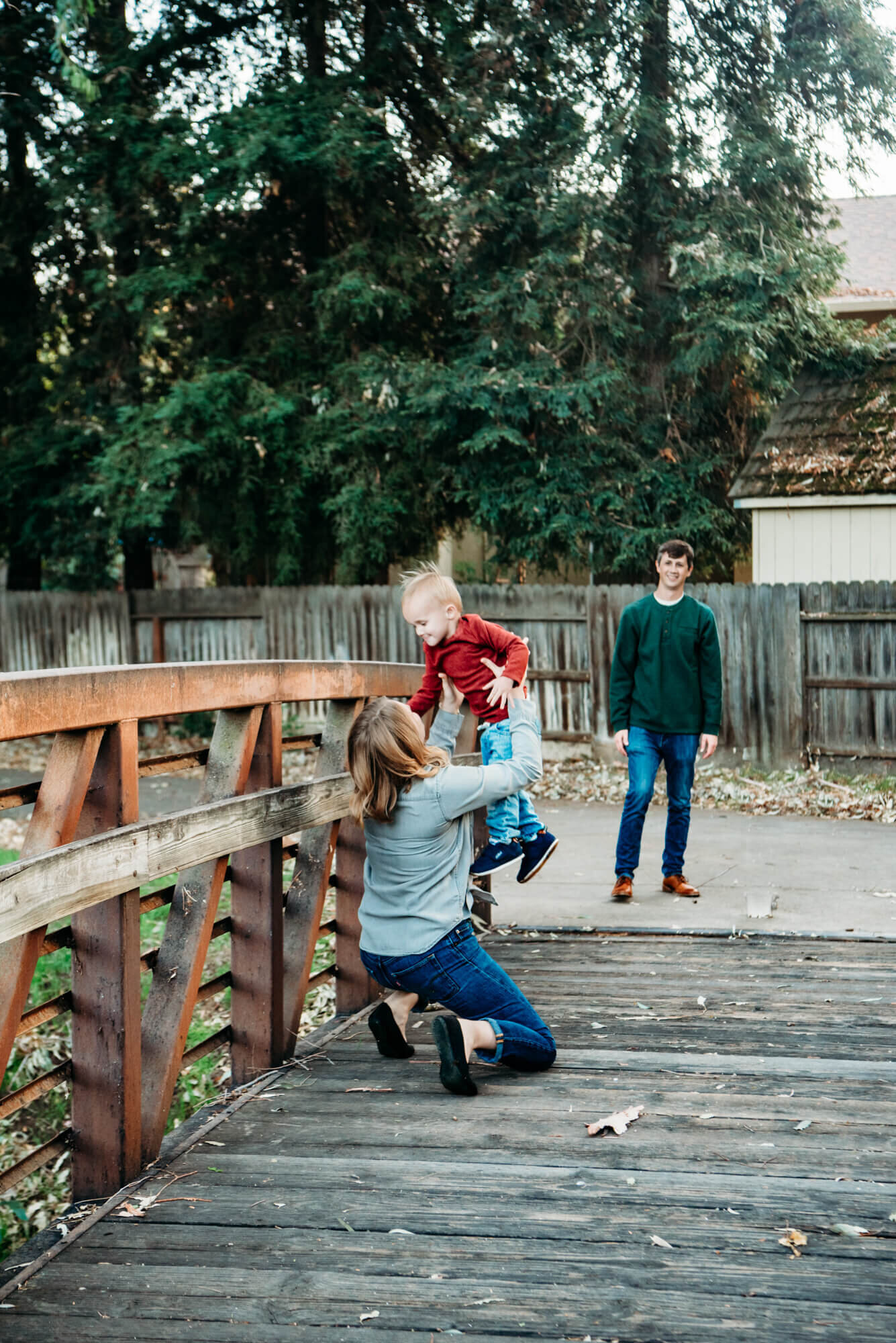 boy runs to mom during family photos at park