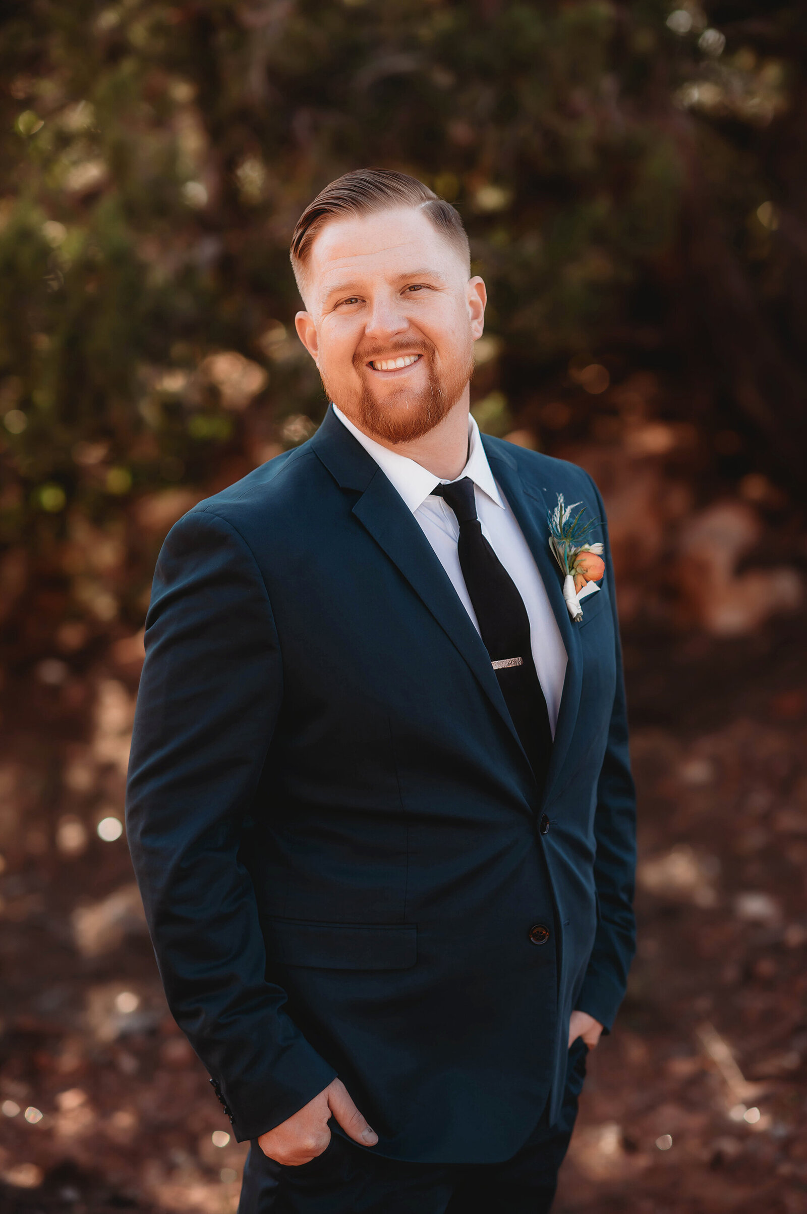 Groom poses for portraits before his Elopement in Sedona, AZ.