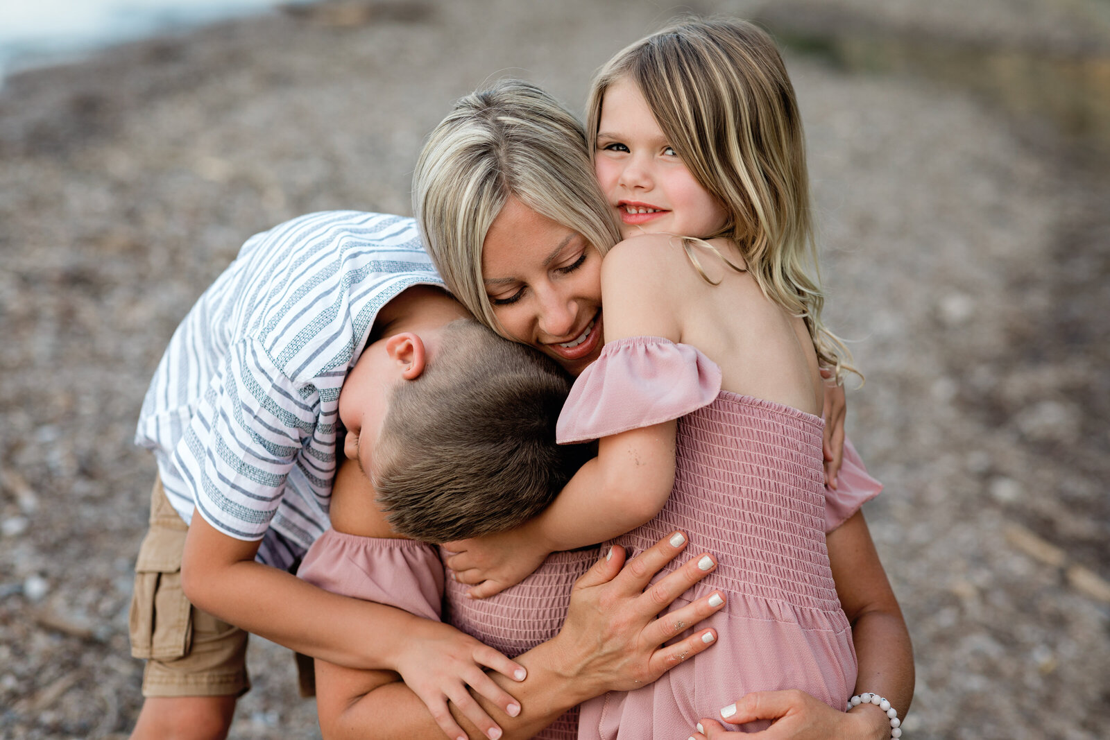 mom and two children hugging for family photos