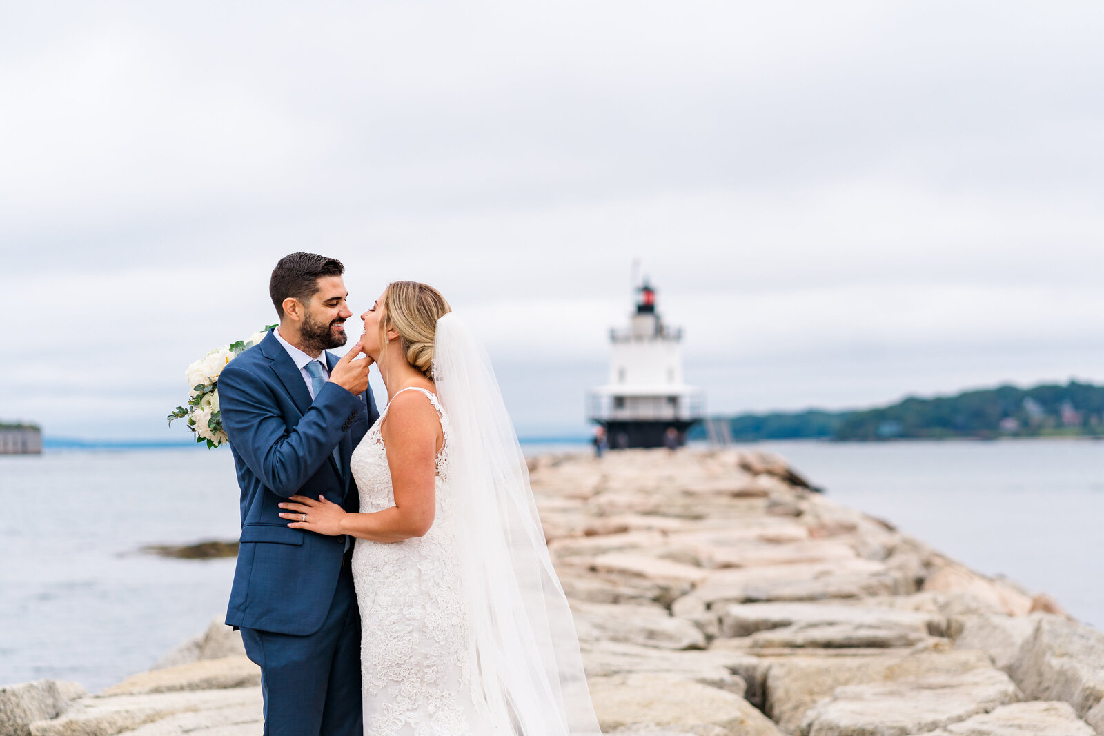 Couple kissing by a Maine lighthouse | Maine elopement photographer | Adventure and Vows
