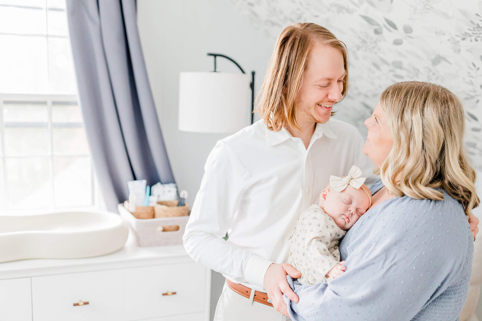 Dad smiling at mom in the nursery