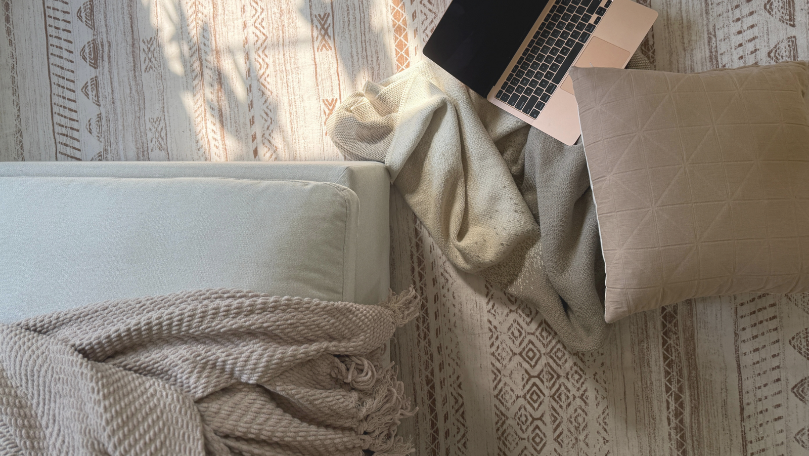 computer open on neutral colored textiles 