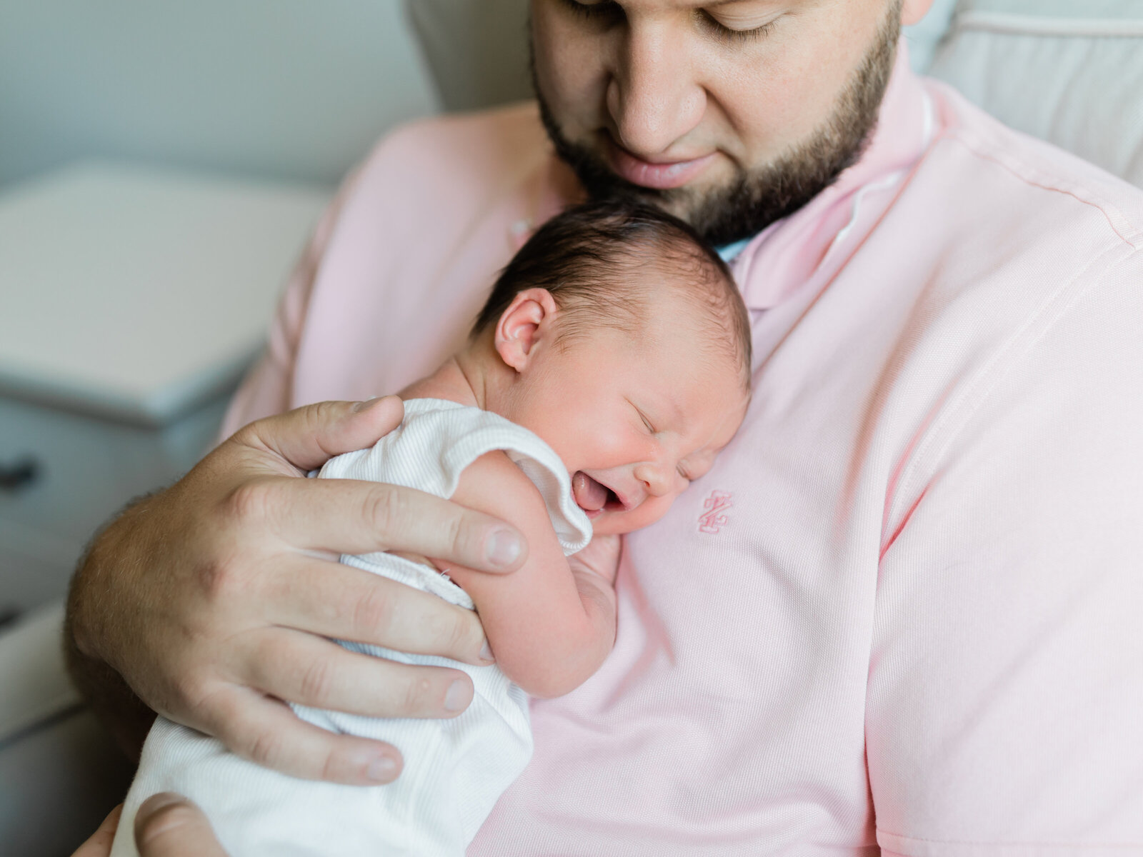 Dad holding newborn baby girl