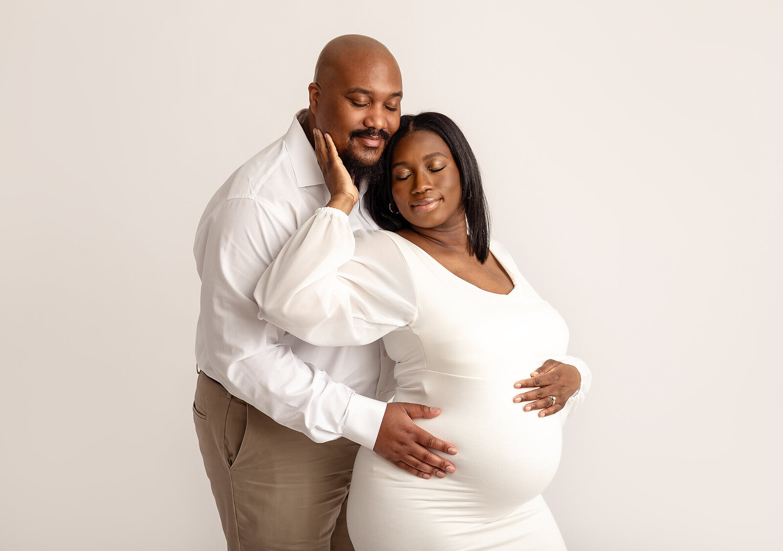 pregnant couple posing in studio for philadelphia maternity photography