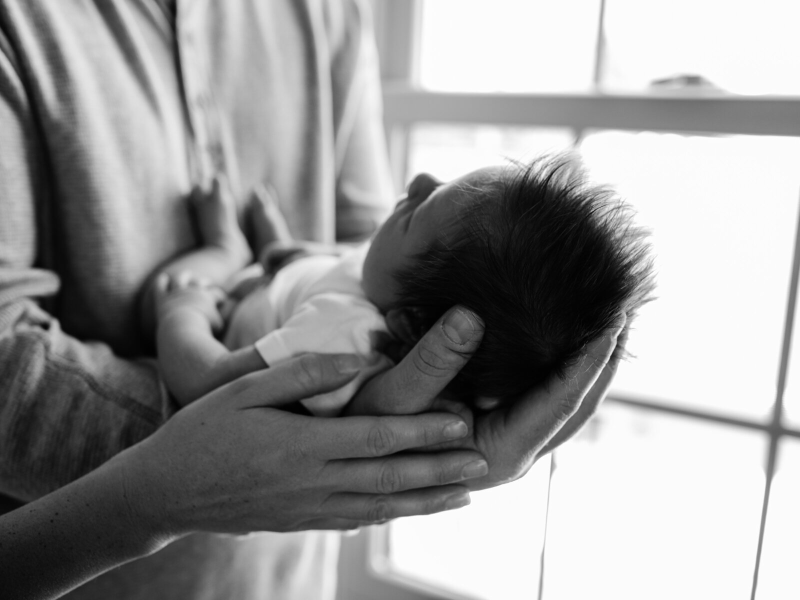black and white photo of dad holding newborn baby boy cleveland newborn photographer