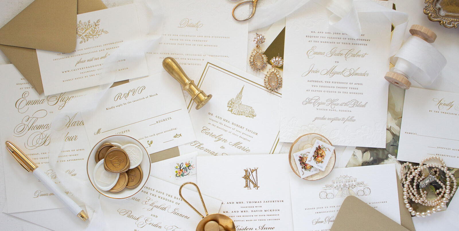collection of gold and white wedding invitations