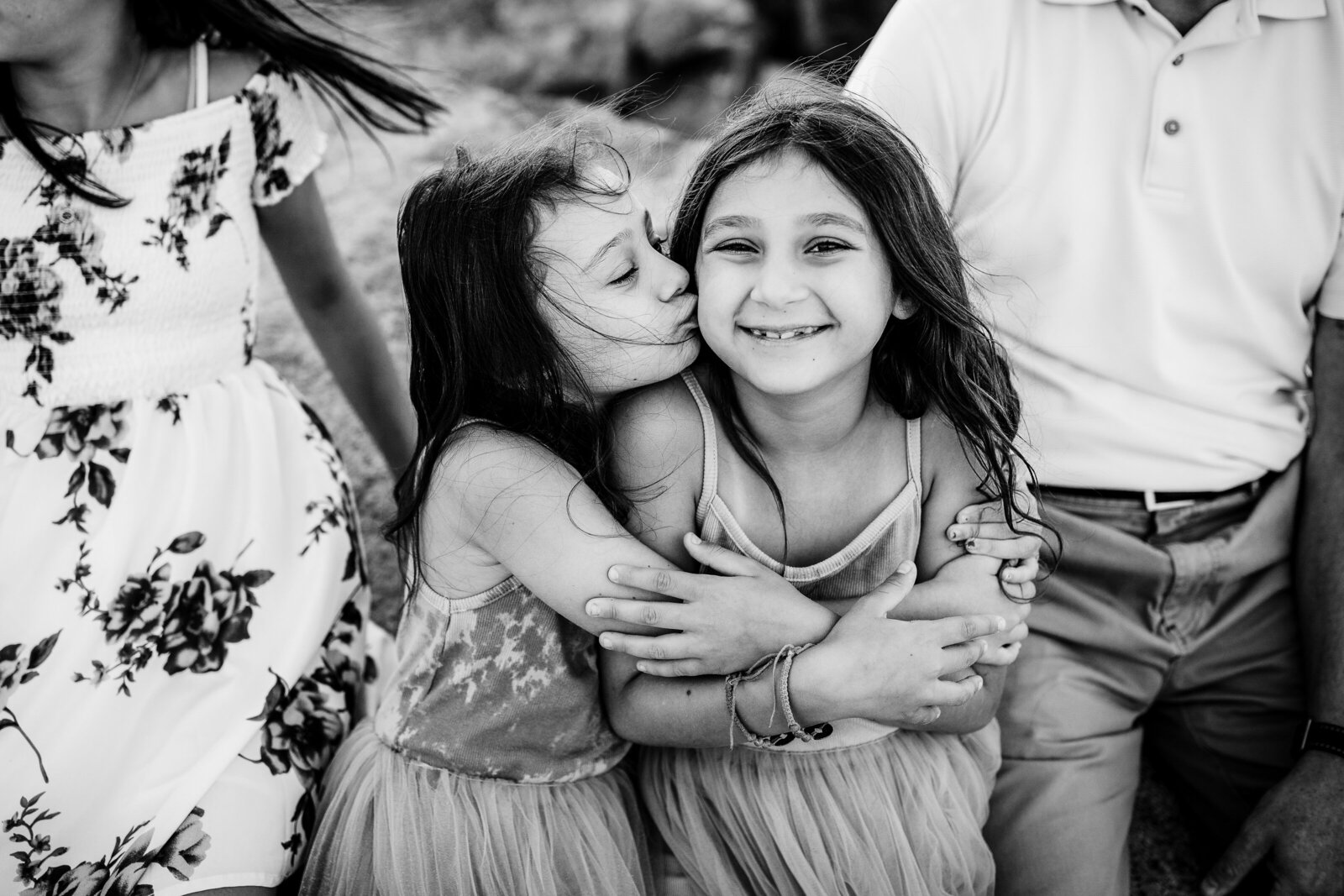 sisters embrace during beach photos in boston