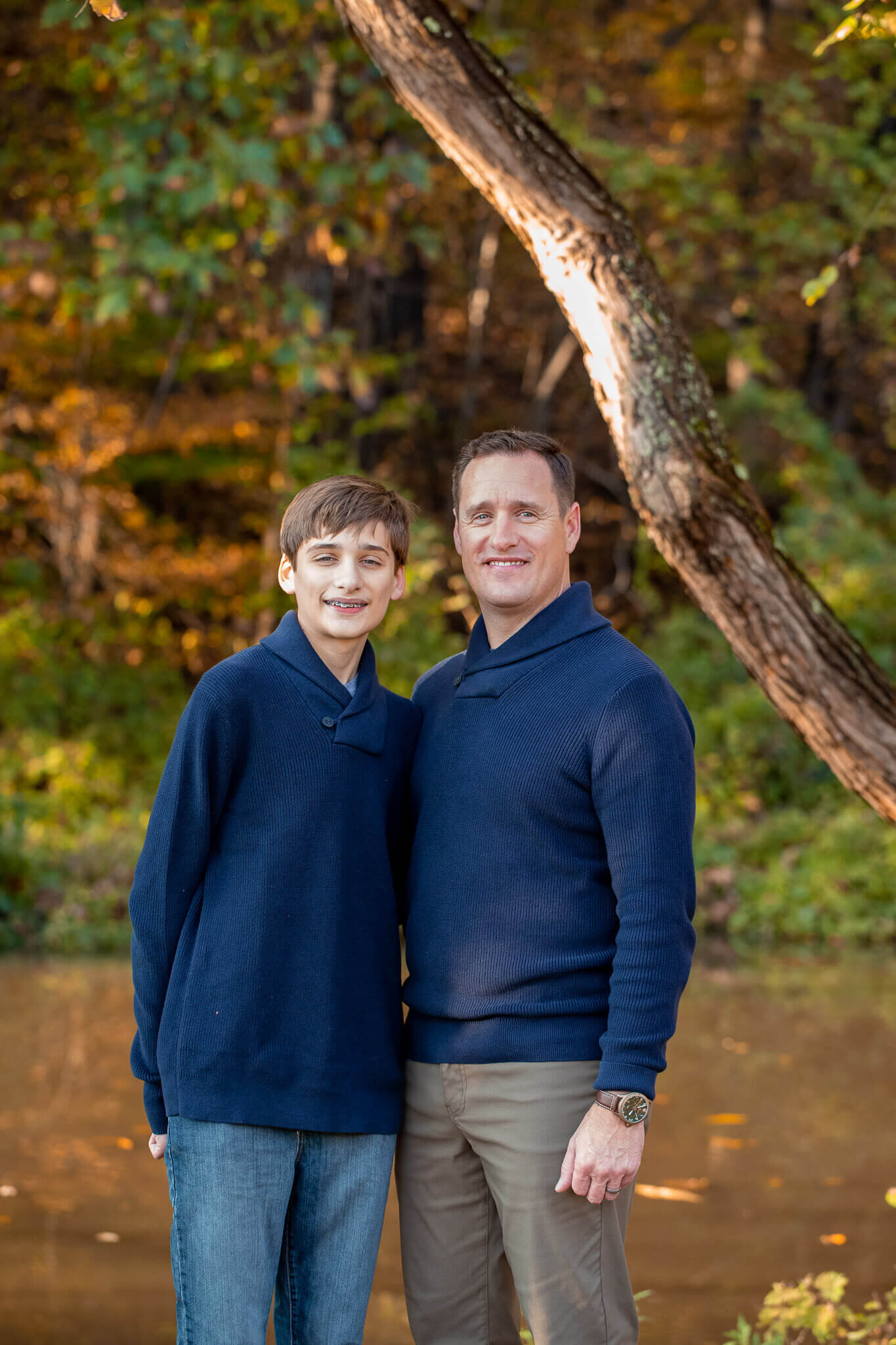 A dad and son posing in front of a stream in Springfield.