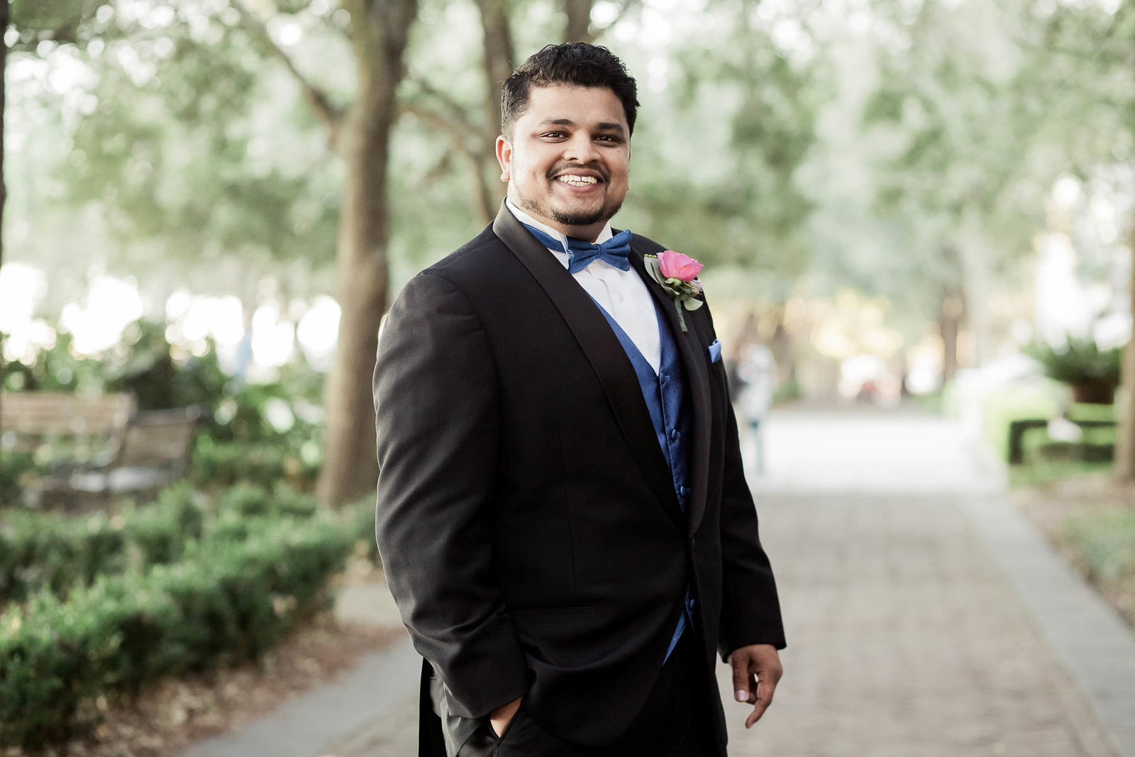 Groom stands under trees at Waterfront Park, South Carolina