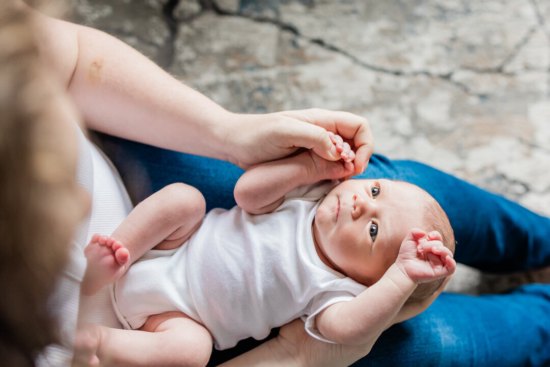 Newborn baby looking at mother