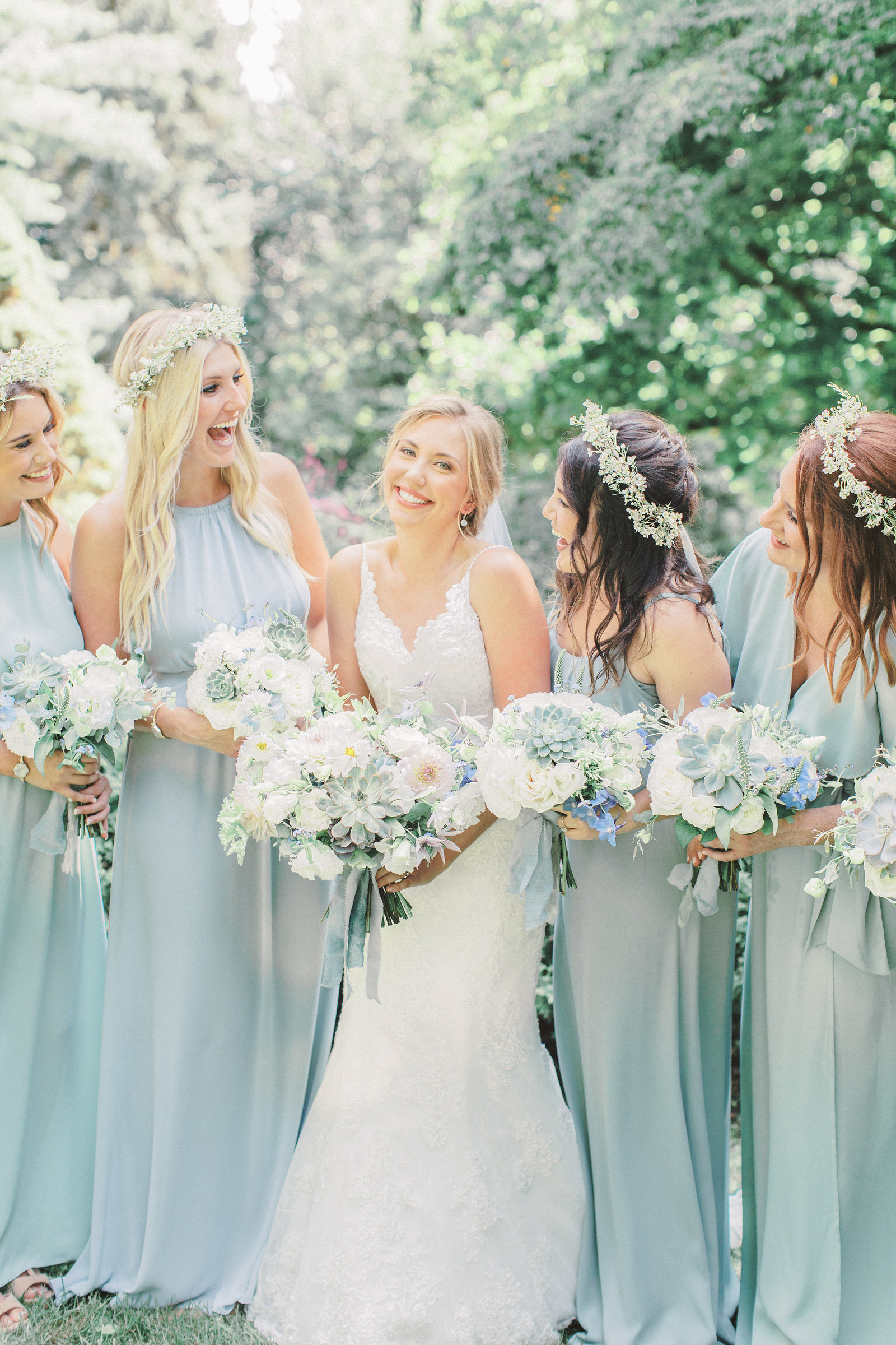 bridesmaids admire the beautiful bride in the gardens at greenville country club